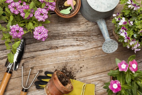 Professional planting service preparing a garden border in Sudbury
